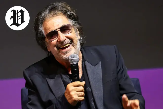 : Al Pacino laughing while holding a microphone during a live interview.