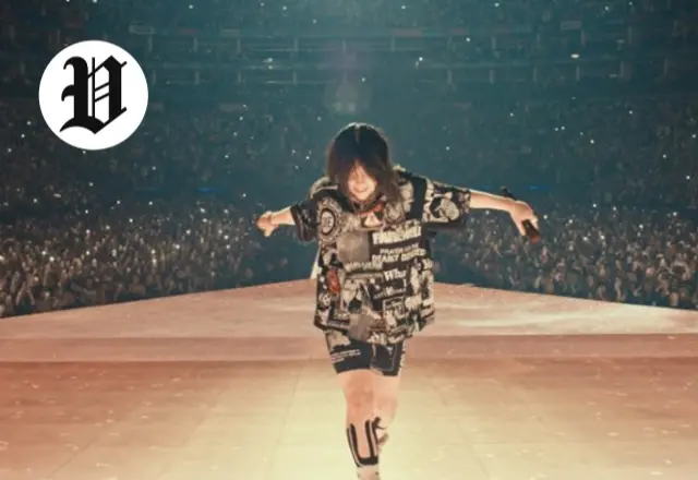 Billie Eilish performing live on stage in front of thousands of fans during her 2025 tour