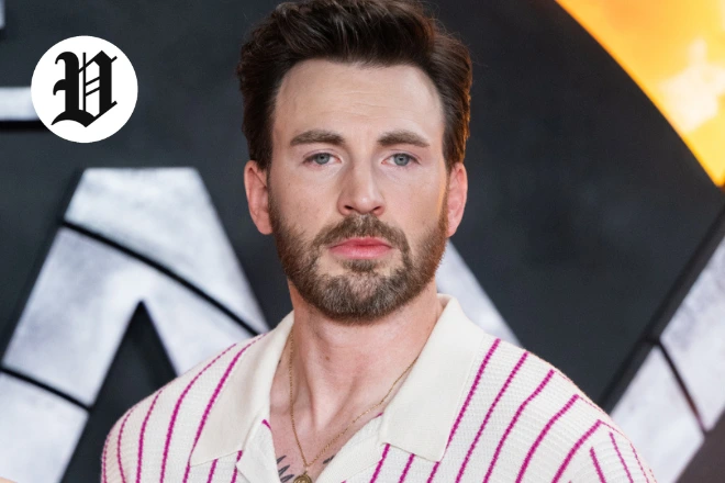 Chris Evans at a red carpet event wearing a striped shirt.