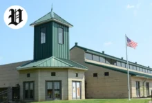 Exterior view of Pavilion Georgetown building with green roof and American flag.