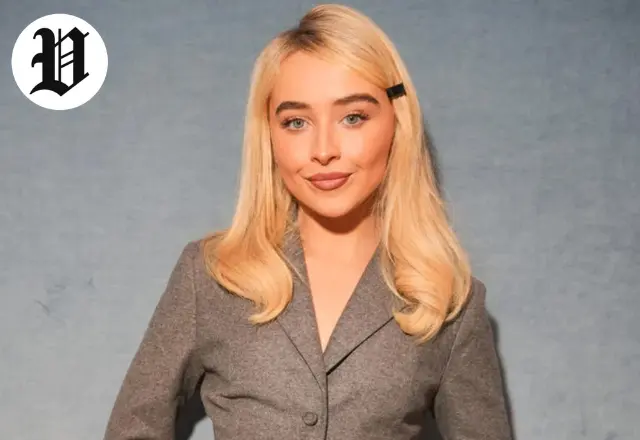 Sabrina Carpenter in a stylish gray suit during a press appearance