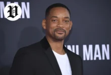 Will Smith at a red carpet event in a black blazer and white shirt