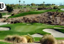 Angel Park Golf Club desert-style course with rolling fairways, sand bunkers, and palm trees under clear skies.