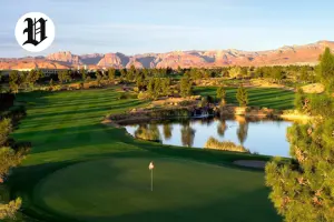 Angel Park Golf Club at sunset with a scenic green, reflective pond, and Red Rock Canyon mountains in the distance.