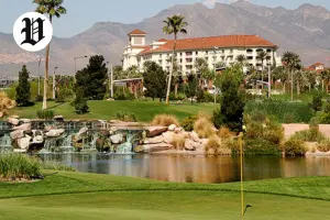 Scenic view of Angel Park Golf Club with lush greens, water features, and a luxury resort backdrop in Las Vegas.