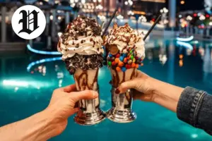 Two extravagant milkshakes topped with whipped cream, chocolate, and candies – Best Desserts in Las Vegas.