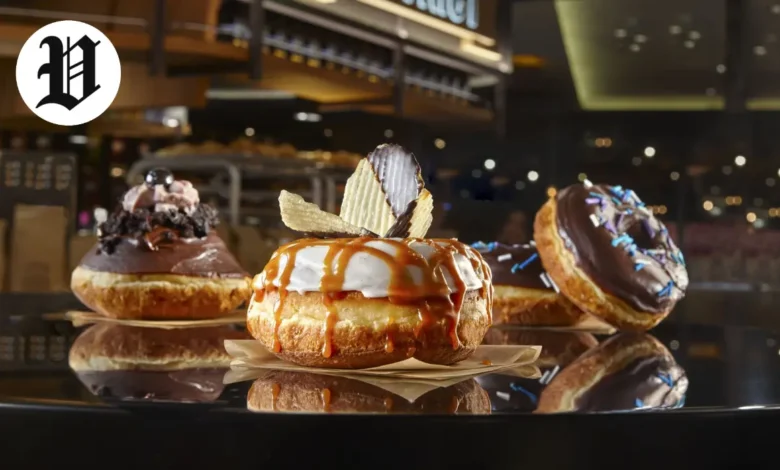 Assorted gourmet donuts with chocolate, caramel, and toppings – Best Desserts in Las Vegas.