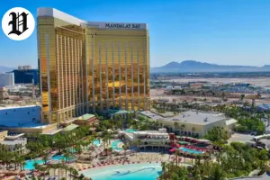 Aerial view of Mandalay Bay, one of the biggest hotels in Las Vegas, with golden towers and pool area.