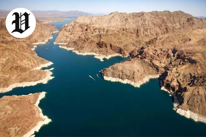 Wide view of Lake Mead near Hoover Dam with clear blue water and desert mountains