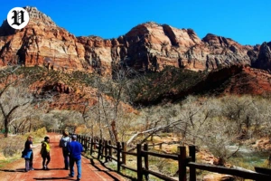Tourists walking riverside trail at Zion after Las Vegas drive.