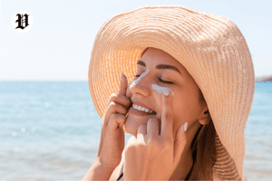 Applying sunscreen to prevent dark spots.