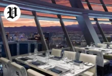Dining room at Top of the World Las Vegas with floor-to-ceiling windows and Strip views.