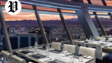 Dining room at Top of the World Las Vegas with floor-to-ceiling windows and Strip views.