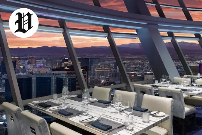 Dining room at Top of the World Las Vegas with floor-to-ceiling windows and Strip views.