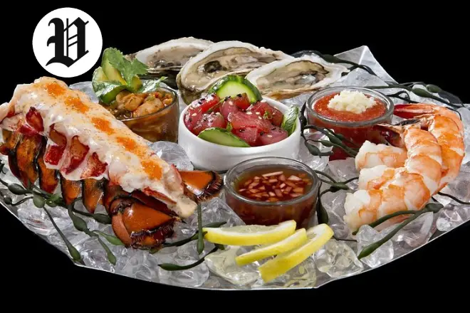 Seafood platter at Top of the World Las Vegas with lobster, shrimp, oysters, and tuna poke.