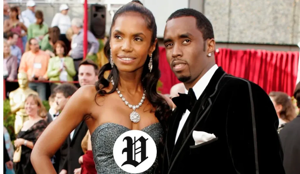 Kim Porter posing on the red carpet in an evening gown beside an unidentified man.